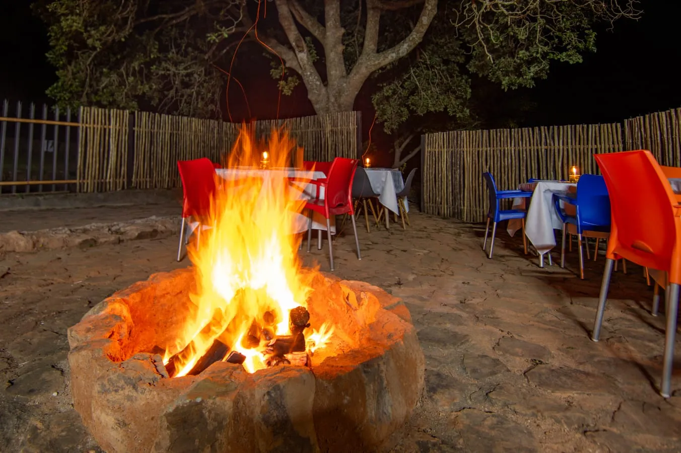 A fire burning in the boma, with tables set around it